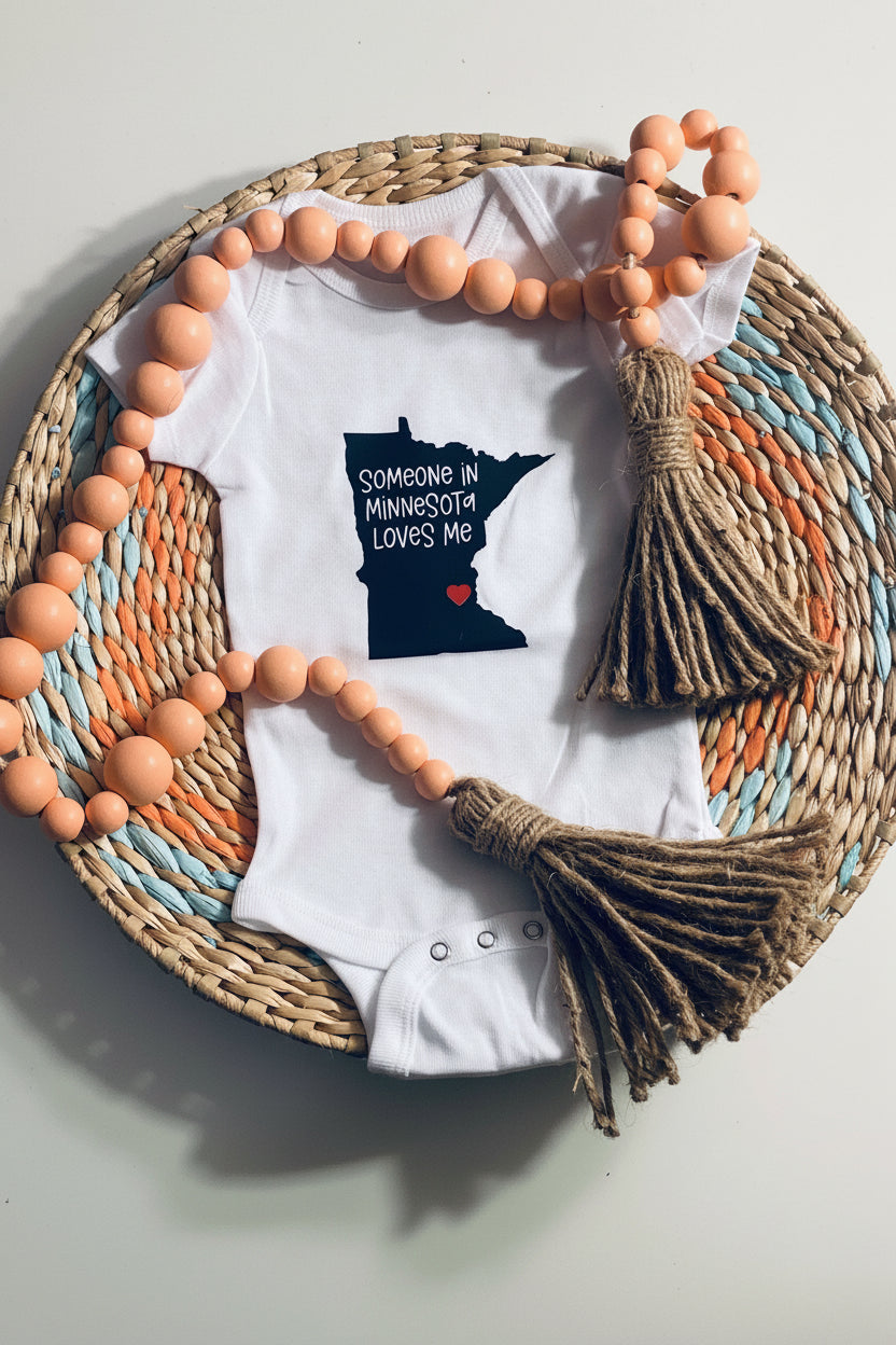 White baby onesie with Minnesota design 